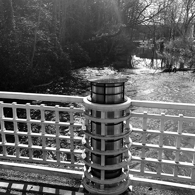 Old lightpole in river the Dommel
